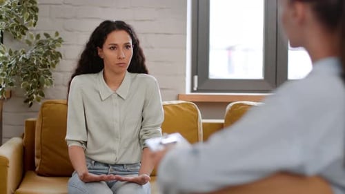 Woman Conversing in Therapy Session on Couch