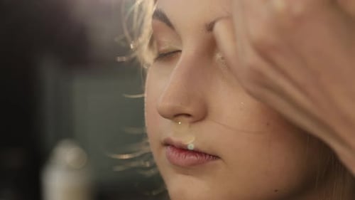 Woman Receiving Makeup Application with Brush Close Up