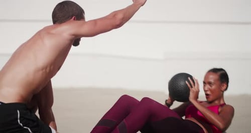 Woman Doing Sit-ups With a Man Helping