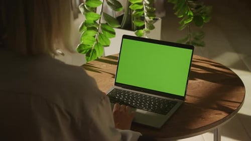 Woman Swiping Sideways on Green Screen Laptop Touchpad