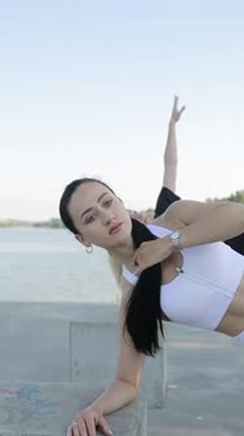 Two Young Women Doing Side Plank Exercises Outdoors