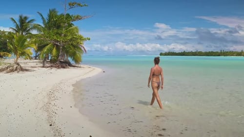 Woman Walking on the White Sand Beach of a Tropical Island Paradise