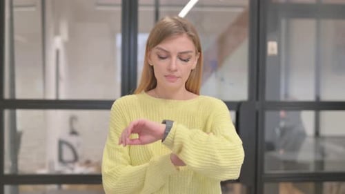 Portrait of Waiting Blonde Young Woman Checking Time