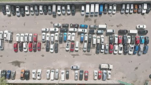 Drone shot of cars at a parking lot.