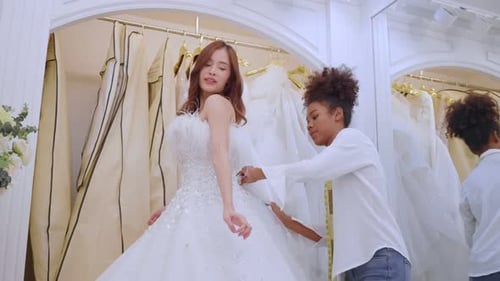 Beautiful bride discussing details with the wedding planner in studio.