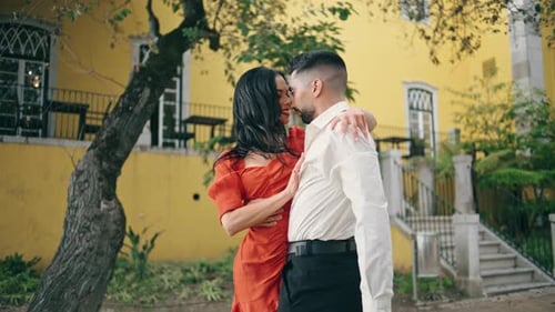 Romantic hispanic lovers smiling together in city park on summer weekend