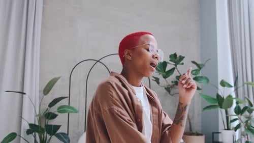 Woman Grooving to Music in Bedroom at Home