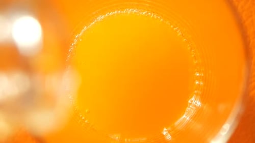 Fresh Orange Juice Being Poured into Glass