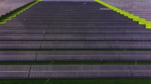 Aerial View of Solar Panel Field on Green Grass
