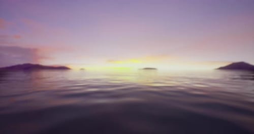 Sunset Over Calm Ocean Waters with Distant Islands and Soft Clouds
