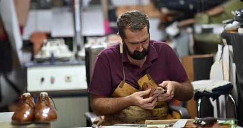 Skilled Shoemaker Meticulously Crafting a Bespoke Leather Shoe By Hand in His Traditional Workshop