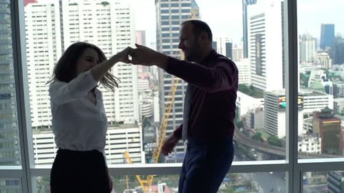 Couple Dancing Together in Office With City View