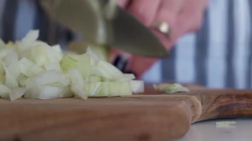 Close Up of Adult Dicing an Onion