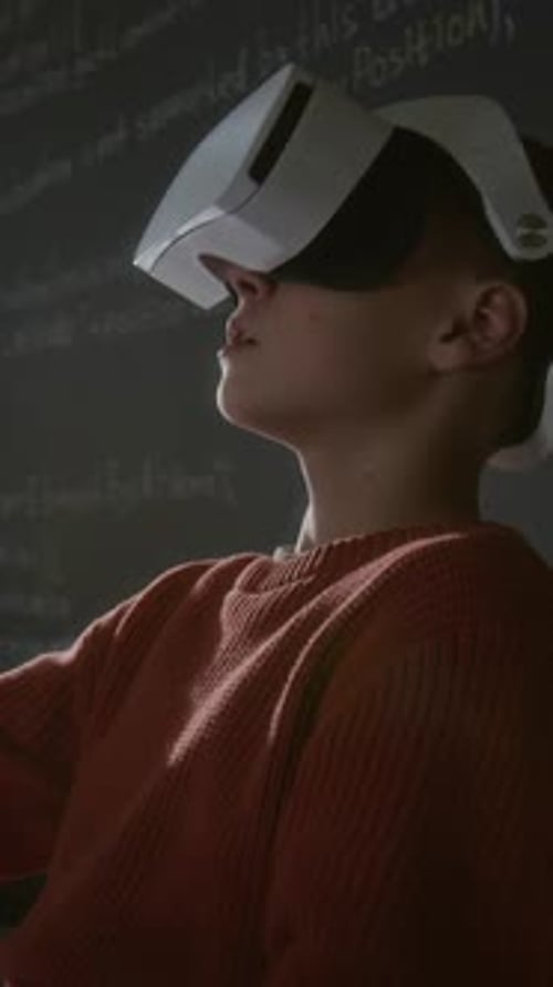 Vertical of Student Using AR Headset and Controller while Developing Code