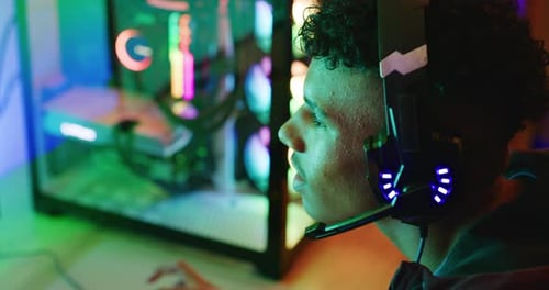 Young Adult Wearing a Headset Looking at Computer