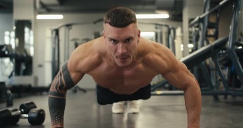 Strong Athletic Man Trains Shirtless in the Gym Doing Pushups Lean Muscular Athlete Staying Healthy