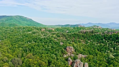 Aerial over Belogradchik sandstone rock formations amid Balkan forestry landscape