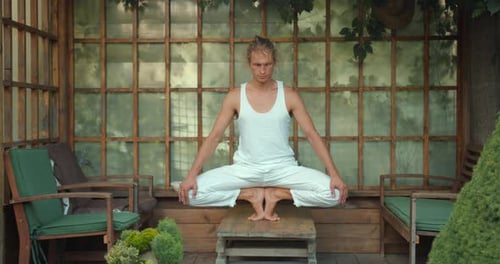 Jovem caucasiano meditando durante a prática de ioga