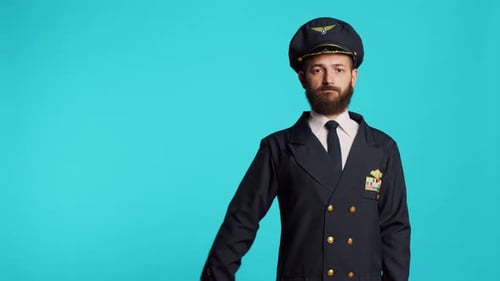 Männliches Model trägt Pilotenuniform und Hut vor der Kamera