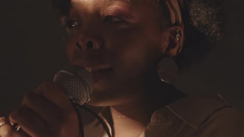 Close Up of Singer Performing with Microphone at Night