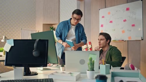 Serious businessmen analyzing final result together in modern looking office