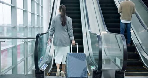 Escalator, luggage and business woman at an airport for international travel
