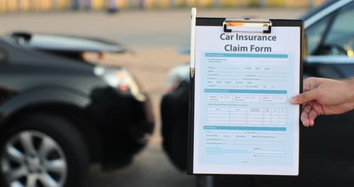 Close Up of a Man Car Insurance Agent Inspecting Damaged Car with Insurance Claim Form Insurance