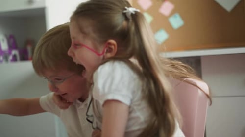 Cheerful Boy and Girl Play with Toys and Felttip Pens