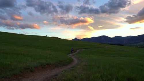 Mountain biker riding in trail at sunset