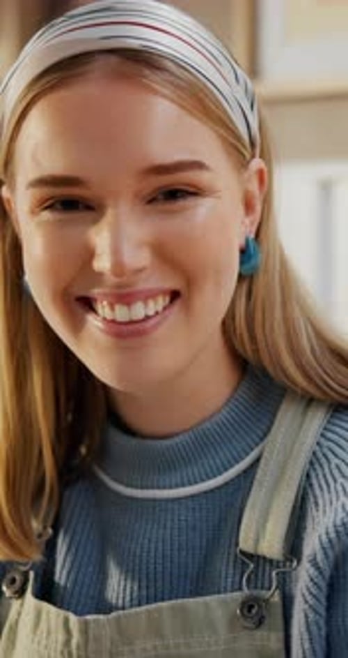 Smiling Blonde Woman in Overalls in Home