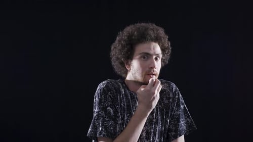 Psychologically troubled man looking strangely at camera.