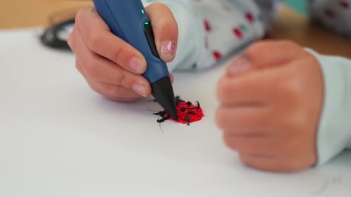 Child Creating Ladybug with 3D Printing Pen