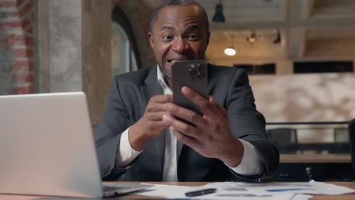 African American Business Man Businessman Winning with Mobile Phone Web Prize Virtual Casino Bet