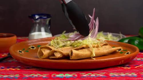Crispy Golden Taquitos Topped with Fresh Shredded Lettuce