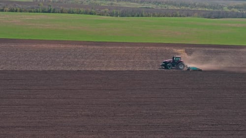 Tractor Plowing A Field On A Farm Aerial