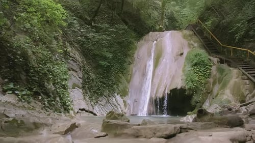 Tourist Stairs Next to a Small Waterfall in the Forest CREATIVE A Beautiful Route for Tourists