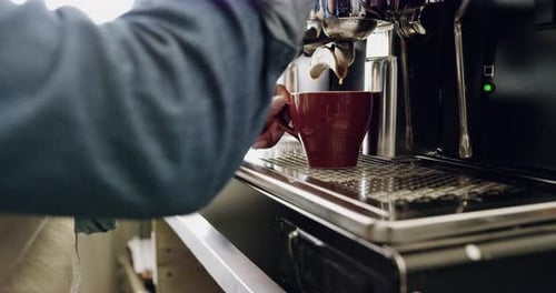 4k video of a barista preparing a beverage at the coffee machine in a cafe