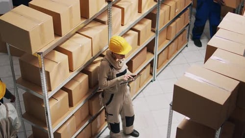 Warehouse Workers Using Tablet for Inventory