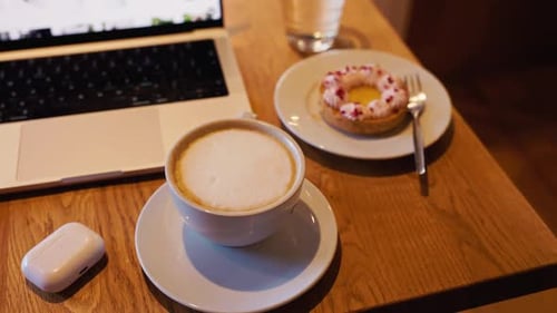 Coffee, Dessert, and Laptop on Wooden Table