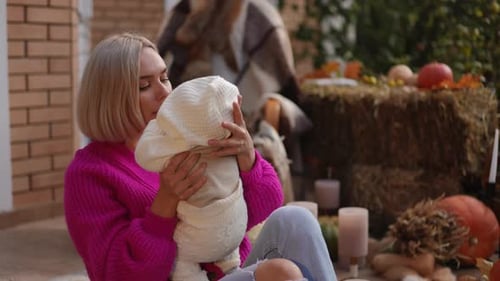 Loving Mother Bonding with Baby Outdoors in Autumn