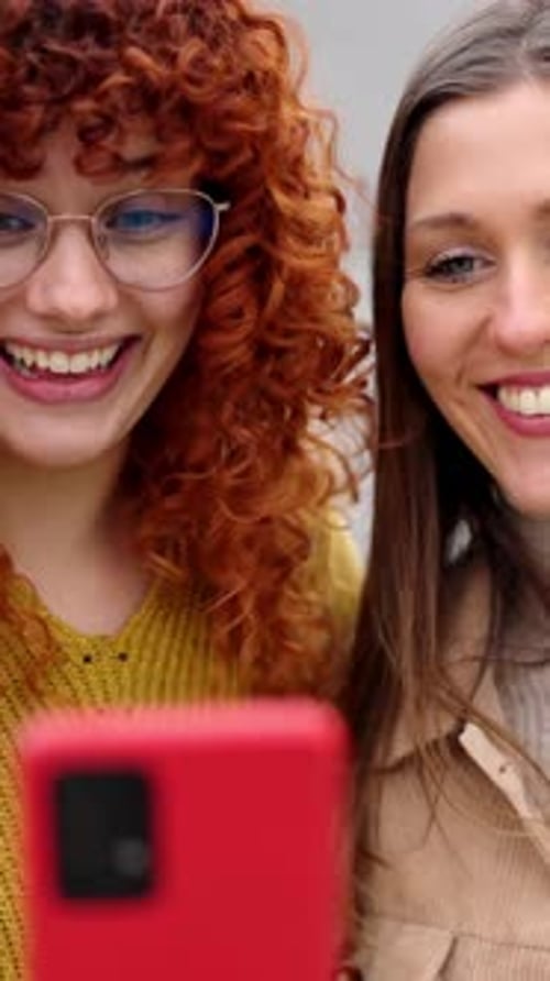 Two Young Women Talking on a Cellphone