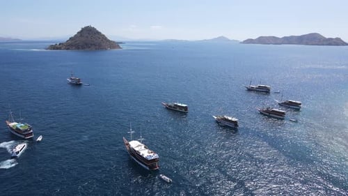 Aerial view of beaches and tourist boat sailing in Kelor Island, Flores Island, Indonesia.