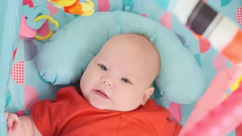 Portrait of Cute Baby a Newborn Girl Playing in the Room