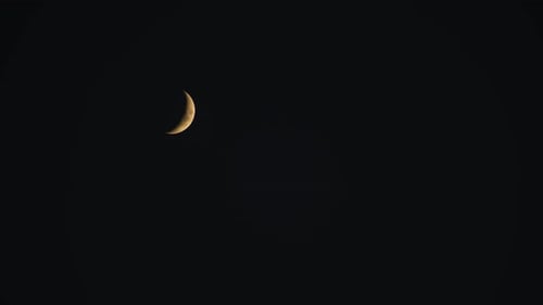Crescent Moon Filmed On Clear Night Sky.