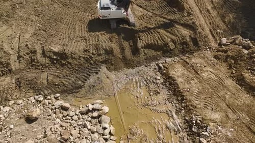 Excavator Loading Dump Truck on Construction Site