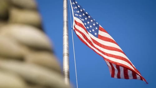 American Flag Waving Proudly on Blue Sky