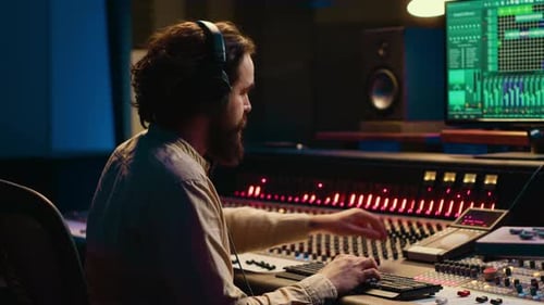Sound Engineer Adjusting Audio in Studio
