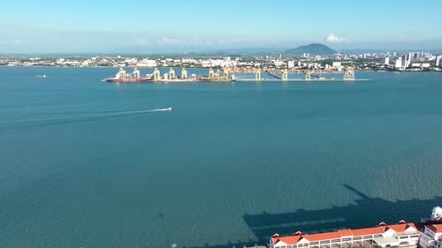 Penang Port container terminal with cityscape view and vast blue waters in Penang Malaysia