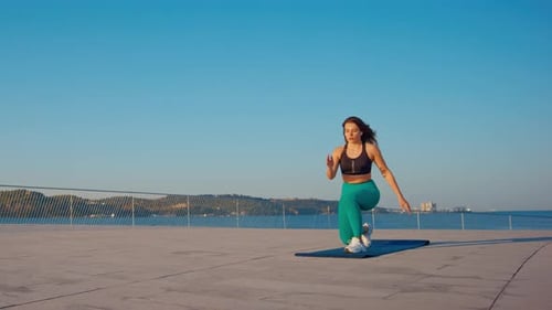 Woman Exercising on Pad Outdoors on Sunny Day