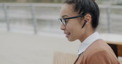 Adult Woman Wearing Earbuds Having a Video Call